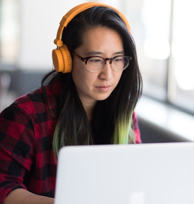 employee taking a e-learning course with headphones